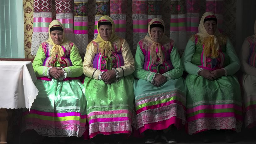 Women in traditional Doukhobor dresses pray at the former Orphanage house where Doukhobors has worshiped for years, on Easter in the remote mountain village of Gorelovka, Georgia, Saturday, May 4, 2024. (AP Photo/Kostya Manenkov)