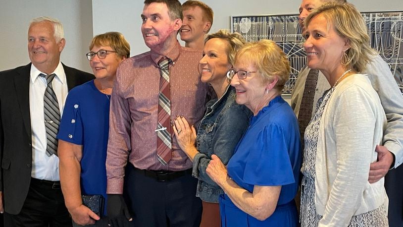 Kevin Pleiman (center) gets his picture taken with his family during a recent event honoring trauma survivors who were treated at Miami Valley Hospital's Level I Trauma Center. SAM WILDOW\STAFF