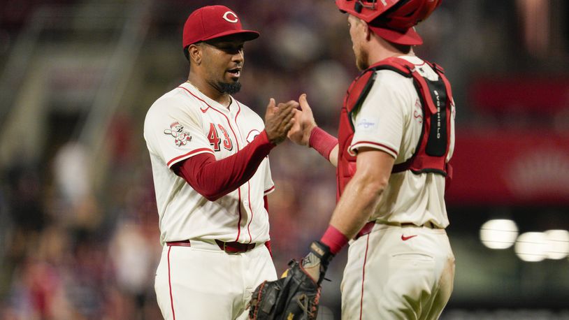 Cincinnati Reds' Alexis Díaz (43) celebrates with teammate Tyler Stephenson following the team's 6-3 victory over the Chicago Cubs, Tuesday, July 30, 2024, in Cincinnati. (AP Photo/Jeff Dean)