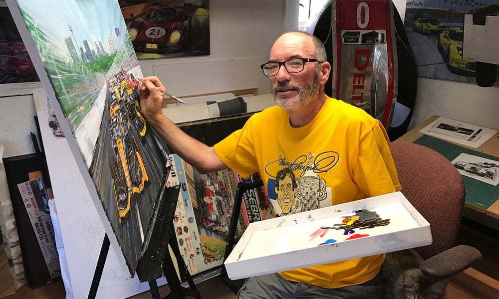 In the studio of his home in Hamilton, artist Roger Warrick works on a scene he painted from the Toronto Indy race. Tom Archdeacon/CONTRIBUTED