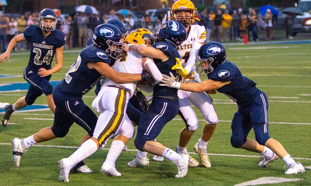 Alter's Noah Jones is stopped by Fairmont during Thursday night's game at Roush Stadium. Fairmont won 24-21. Jeff Gilbert/CONTRIBUTED