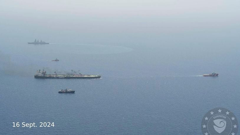 In this photo released of EUNAVFOR ASPIDES, the EU naval mission working in the Red Sea, on the X-platform formerly known as Twitter, on Sept. 16, 2024, the Greek-flagged oil tanker MV-Sounion, left, is towed. Salvagers successfully towed a Greek-flagged oil tanker ablaze for weeks after attacks by Yemen's Houthi rebels to a safe area without any oil spill, a European Union naval mission said Monday. (EUNAFOR ASPIDES via AP)