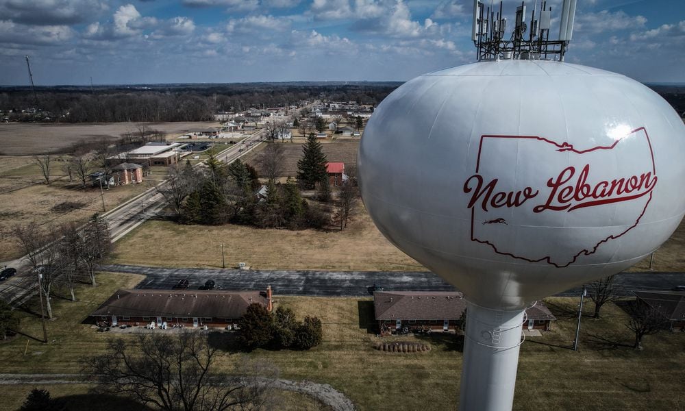 The water tower stands on the west side of the village of New Lebanon Ohio. The village council recently put 5 village leaders on leave. Jim Noelker/Staff