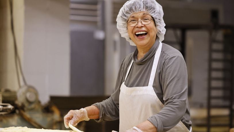 Vera Slamka smiles as she does what she loves in the kitchen at Central Pastry Tuesday, Aug. 13, 2024 on Central Avenue in Middletown. Vera and her husband, John, are celebrating owning Central Pastry for 40 years. NICK GRAHAM/STAFF