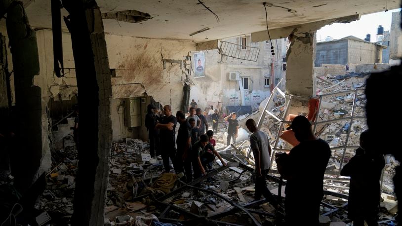 Palestinians examine the damage following an Israeli airstrike in the West Bank city of Tulkarem, which Palestinian health officials say killed 18 people and the Israeli military says took out a Hamas leader, on Friday, Oct. 4, 2024. (AP Photo/Nasser Nasser)