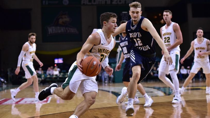 Wright State point guard Cole Gentry looks to drive past North Florida’s Ryan Burkhardt during Saturday’s game at the Nutter Center. Joseph Craven/CONTRIBUTED