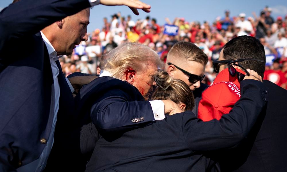  Secret Service agents surround former President Donald Trump after being shot during a campaign rally in Butler, Pa., Saturday, July 13, 2024. Immediately following Saturdayâs shooting a bipartisan pair of lawmakers in the House said they have plans to introduce a bill that would enhance the secret service protection for both President Biden and Mr. Trump. (Doug Mills/The New York Times) 