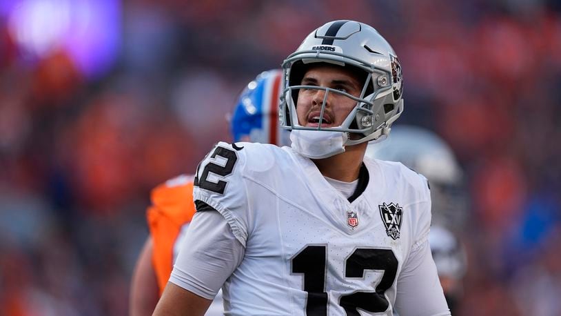 Las Vegas Raiders quarterback Aidan O'Connell looks at the scoreboard after throwing an incomplete pass in the second half of an NFL football game against the Denver Broncos Sunday, Oct. 6, 2024, in Denver. (AP Photo/David Zalubowski)