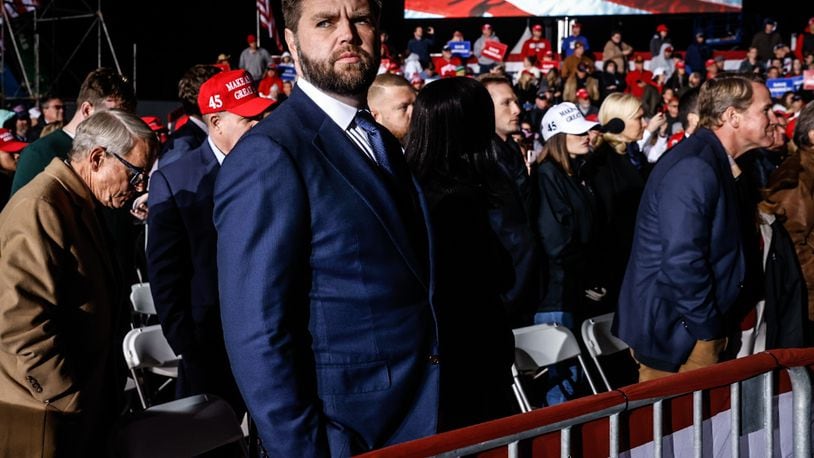 Ohio Senator elect, J.D. Vance listens to former president Donald J. Trump at a rally held November 7, 2022 at the Dayton International Airport. JIM NOELKER/STAFF