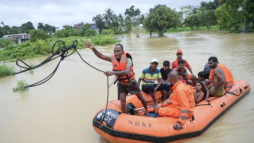 A team from the National Disaster Response Force (NDRF) transports people to safety through a flooded area following incessant rains in Agartala, north eastern Tripura state, India, Thursday, Aug. 22, 2024. (AP Photo/Abhisek Saha)