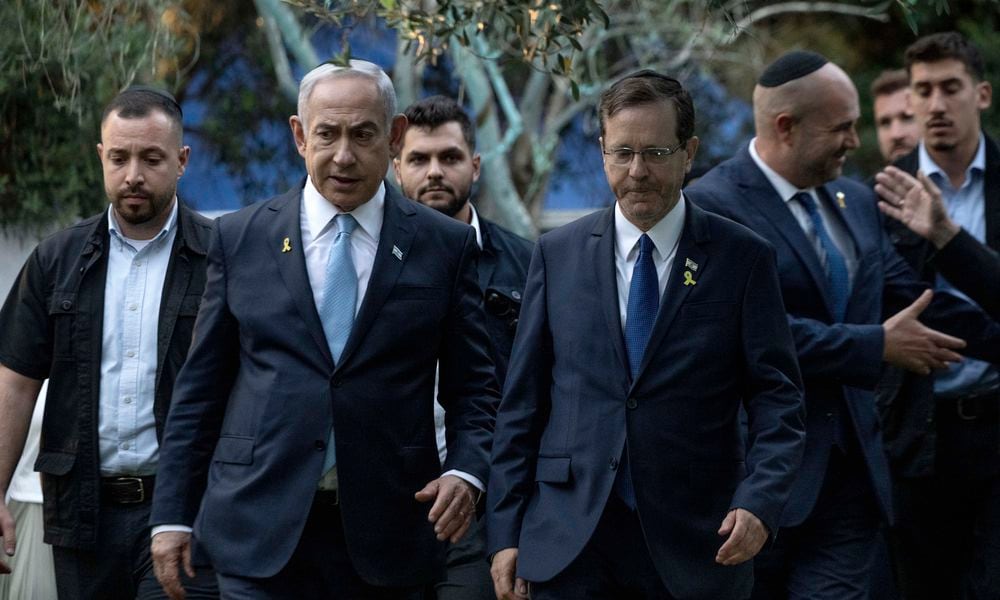 Israeli Prime Minister Benjamin Netanyahu, left, walks with President Isaac Herzog, center right, at the state memorial for Ze'ev Jabotinsky, at Mount Herzl Military Cemetery in Jerusalem, Sunday, Aug. 4, 2024. (Naama Grynbaum/Pool Photo via AP)