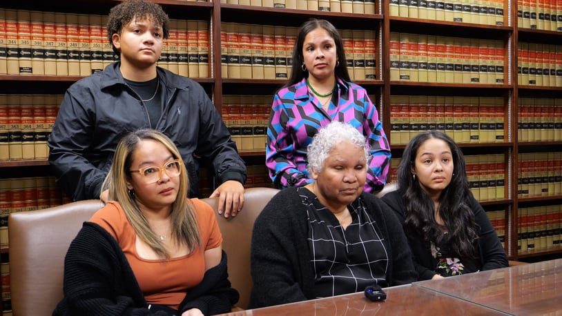 Family members of slain Dayton Police Detective Jorge DelRio, in a video and photograph provided Monday by Dayton police. From left: Seated is Veronica DelRio. Standing behind her is Naya DelRio. At the center is Kathy DelRio. Seated on Kathy's left is Erica Hampton. And standing behind Kathy is Ariel Bush.