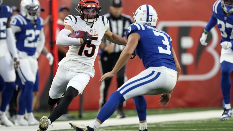 Cincinnati Bengals' Charlie Jones (15) runs from Indianapolis Colts place kicker Spencer Shrader (3) while returning a kickoff during the first half of a preseason NFL football game, Thursday, Aug. 22, 2024, in Cincinnati. (AP Photo/Carolyn Kaster)