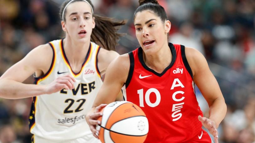 Las Vegas Aces guard Kelsey Plum (10) takes the ball past Indiana Fever guard Caitlin Clark (22) during the first half of an WNBA basketball game Tuesday, July 2, 2024, in Las Vegas. (Steve Marcus/Las Vegas Sun via AP)