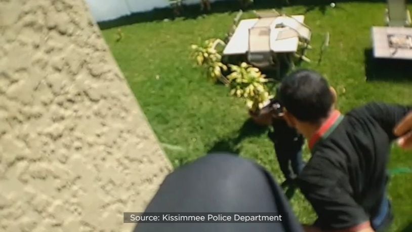 Police body camera video shows the man on the edge of the roof, about 9 feet above the ground. (Kissimmee Police Department)