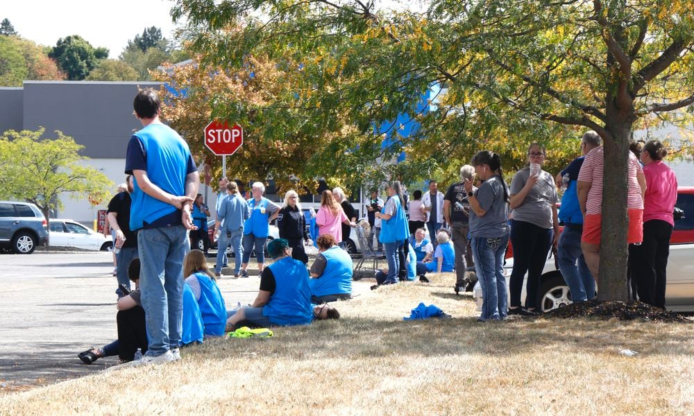 Walmart employees wait in the parking lot after the Bechtle Avenue store was evacuated due to a threat Wednesday, Sept. 18, 2024. BILL LACKEY/STAFF