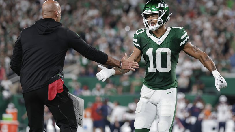 New York Jets wide receiver Allen Lazard (10) is congratulated by New York Jets head coach Robert Saleh after Lazard scored a touchdown against the New England Patriots during the first quarter of an NFL football game, Thursday, Sept. 19, 2024, in East Rutherford, N.J. (AP Photo/Adam Hunger)