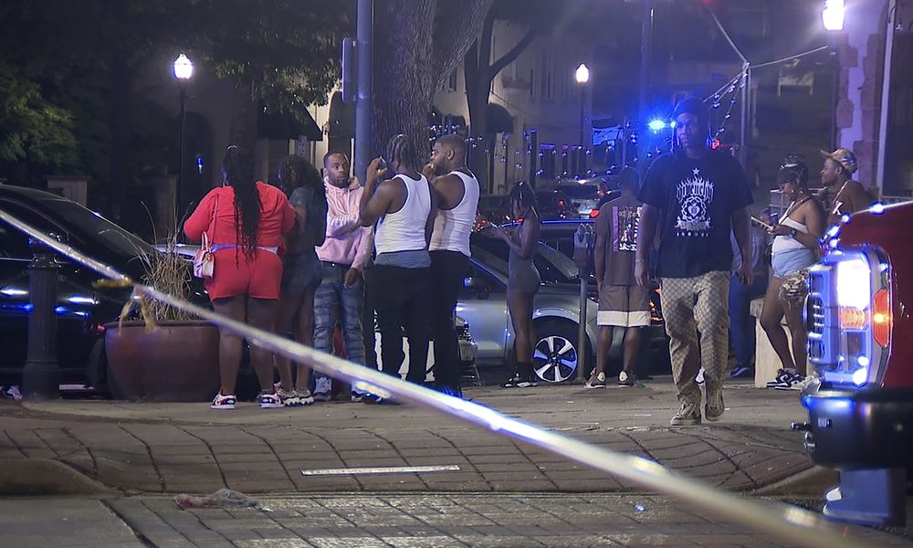 This image provided by WBMA shows bystanders near the scene of a shooting in Birmingham, Ala., Sunday, Sept. 22, 2024. (Bill Castle/WBMA via AP)