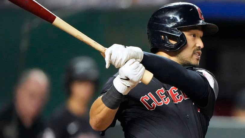 Cleveland Guardians' Steven Kwan watches hit two-run single during the eighth inning of a baseball game against the Kansas City Royals Tuesday, Sept. 3, 2024, in Kansas City, Mo. (AP Photo/Charlie Riedel)