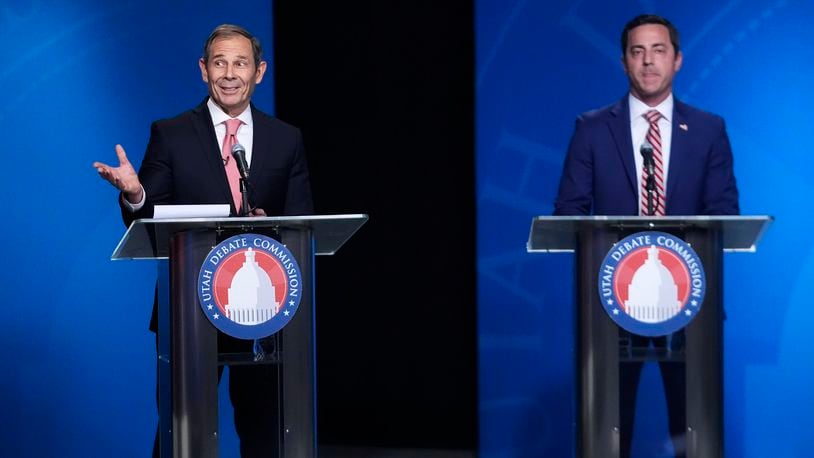 U.S. Rep. John Curtis, left, reacts to a statement made from Trent Staggs, right, during the Utah Senate primary debate for Republican contenders battling to win the seat of retiring U.S. Sen. Mitt Romney, Monday, June 10, 2024, in Salt Lake City. (AP Photo/Rick Bowmer, Pool)