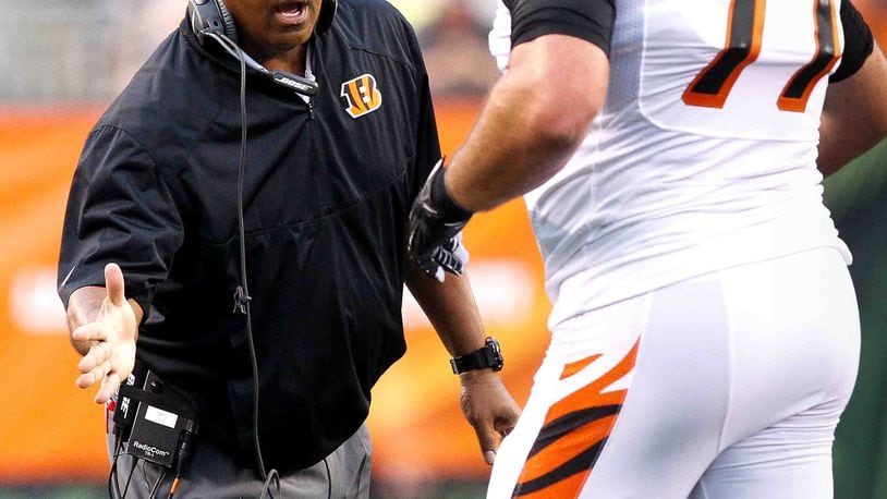 Cincinnati Bengals head coach Marvin Lewis high-fives offensive tackle Andrew Whitworth (77) during Saturday night's preseason game against the Jets Aug. 16, 2014, at Paul Brown Stadium in Cincinnati. NICK DAGGY / STAFF