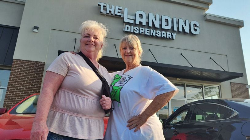 Becky Vliege, left, and Carey Farmer, from Liberty Twp. sat in their car as the first to arrive at The Landing Dispensary in Monroe on Tuesday, Aug. 6, 2024. NICK GRAHAM / STAFF