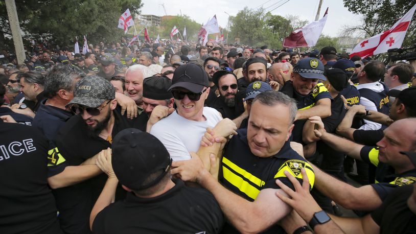 FILE - Police block Georgian opponents of gay rights as they try to interfere a pride party in Tbilisi, Georgia, Saturday, July 8, 2023. (AP Photo/Zurab Tsertsvadze, File)