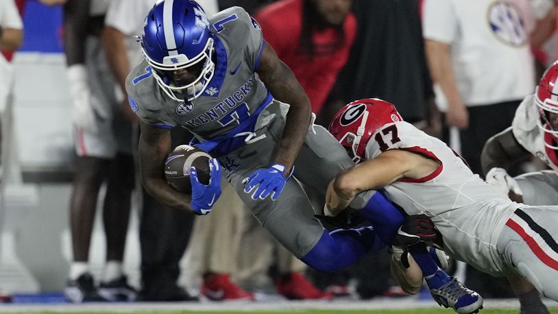 Kentucky wide receiver Barion Brown (7) is tackled by Georgia defensive back Dan Jackson (17) during the second half of an NCAA college football game, Saturday, Sept. 14, 2024, in Lexington, Ky. (AP Photo/Darron Cummings)