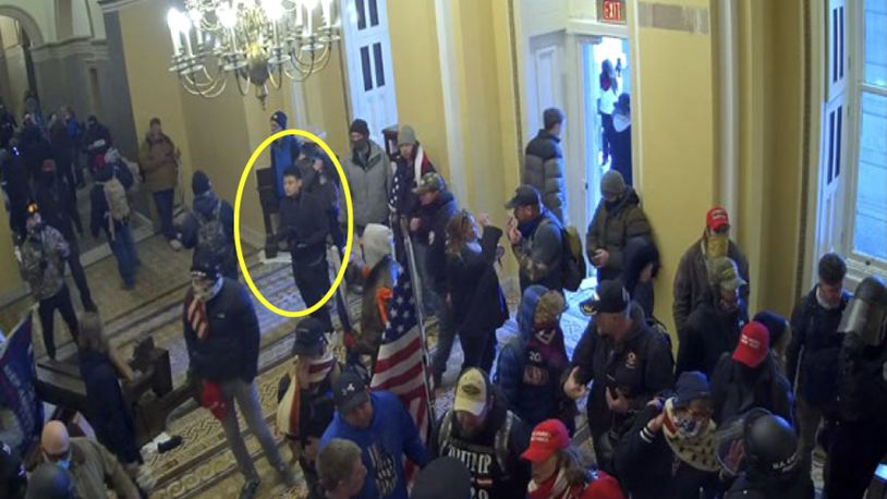 This image from video from the Justice Department in the statement of facts supporting an arrest warrant, and annotated by the source, shows Kevin Alstrup, circled in yellow, a U.S. State Department diplomatic security officer, entering the U.S. Capitol on Jan. 6, 2021, in Washington. (Justice Department via AP)