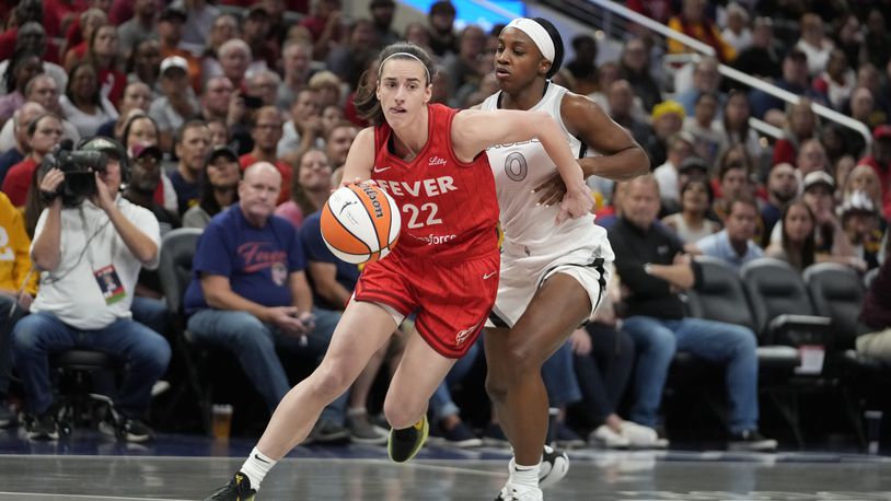 Indiana Fever's Caitlin Clark (22) goes to the basket against Las Vegas Aces' Jackie Young (0) during the first half of a WNBA basketball game, Wednesday, Sept. 11, 2024, in Indianapolis. (AP Photo/Darron Cummings)