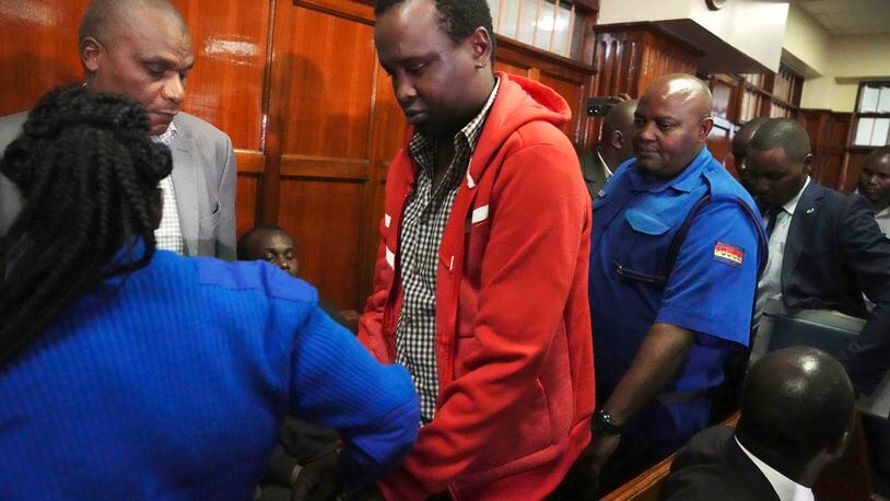 FILE - Kevin Adam Kinyanjui Kangethe is escorted out of the courtroom at the Milimani law court in Nairobi, Kenya, on Feb. 14, 2024. A Kenyan man wanted in Massachusetts to face murder charges has been extradited nearly a year after he fled the United States. (AP Photo/Brian Inganga, File)