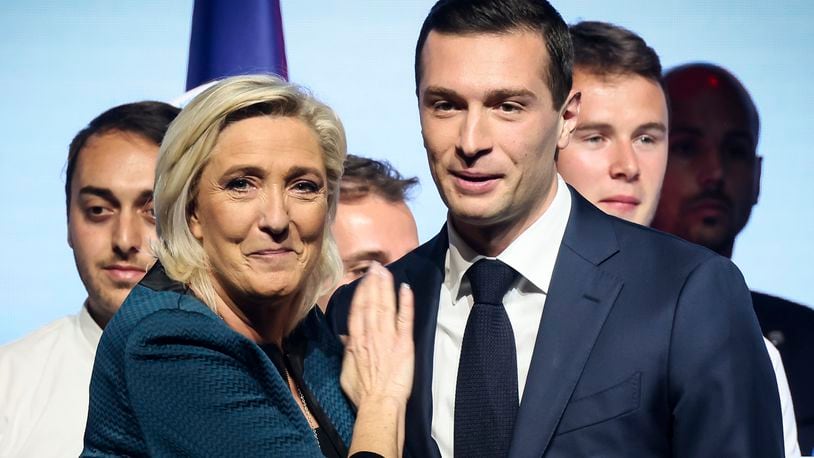FILE - Leader of the French far-right National Rally Marine Le Pen, left, and lead candidate of the party for the upcoming European election Jordan Bardella during a political meeting on June 2, 2024 in Paris. At just 28 years old, Jordan Bardella has led the French far right to a landslide victory in the European Parliament election in June. After voters propelled Marine Le Pen's National Rally to a strong lead in the first round of national legislative elections on Sunday, Bardella has turned to rallying supporters to grant Marine Le Pen's party an absolute majority in the decisive round of voting on July 7 and make him the prime minister of France. (AP Photo/Thomas Padilla, File)