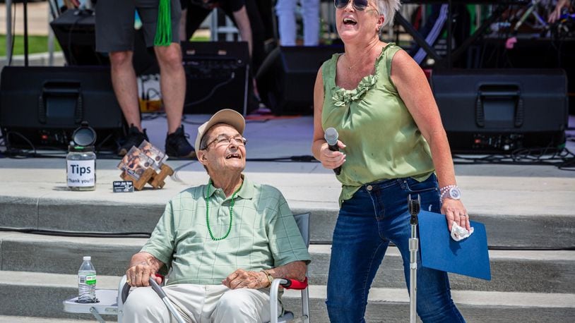 Ron Holp, founder of downtown Miamisburg business Ron’s Pizza and one of the creators of the Rock ‘N’ Green Tomato Festival, was honored at the festival Saturday at the city’s new Riverfront Park. Miamisburg Mayor Michelle Collins (right) presented Holp with a proclamation. CONTRIBUTED