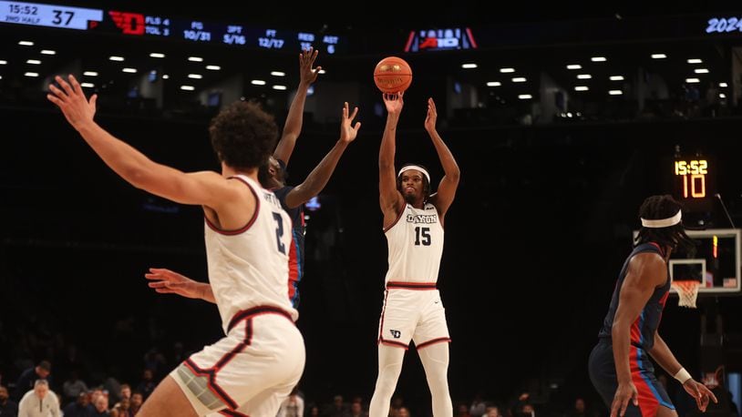 Dayton's DaRon Holmes II shoots a 3-pointer against Duquesne in the Atlantic 10 Conference tournament quarterfinals on Thursday, March 14, 2024, at the Barclays Center in Brooklyn, N.Y. David Jablonski/Staff