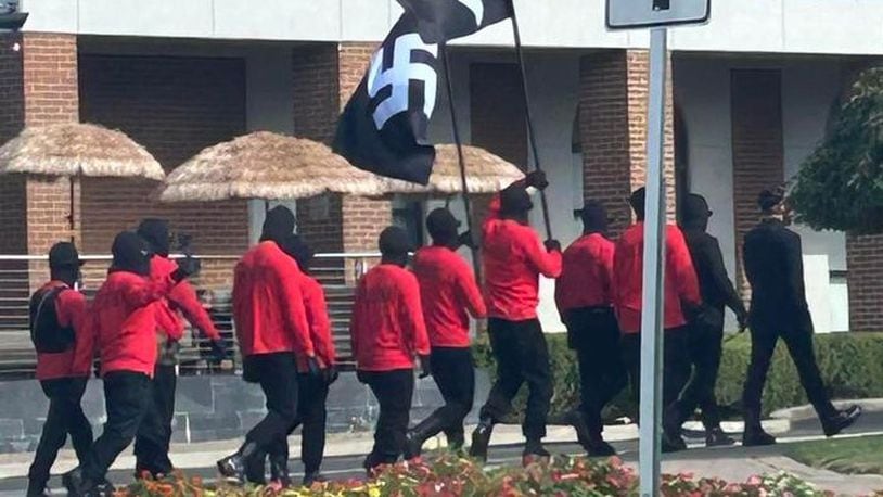 12 people carrying swastika flags and rifles while wearing ski masks walked around downtown Springfield during the Jazz & Blues Fest on Saturday, Aug. 10, 2024. Contributed photo, courtesy Chelsea Shirk Weber.