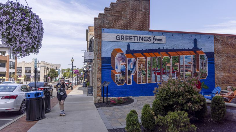 
                        FILE — A “Greetings from Springfield” mural in Springfield, Ohio, on Aug. 27, 2024. In Springfield, threats leave Haitian residents shaken; tension hangs over the city after a week of closings and lockdowns, and the strain of recent months has led some Haitian immigrants to consider moving to bigger cities. (Maddie McGarvey/The New York Times)
                      