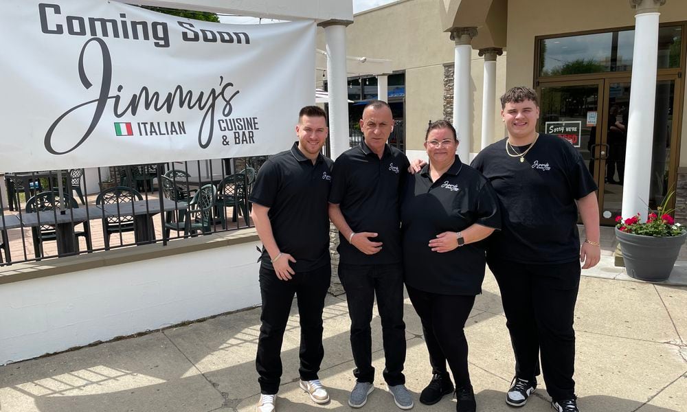 Jimmys Italian Cuisine & Bar is opening its doors in downtown Dayton at 824 E. Fifth St. on Wednesday, May 1. Pictured is Owner Mo Jusufi with his wife, Mira, and two sons. NATALIE JONES/STAFF