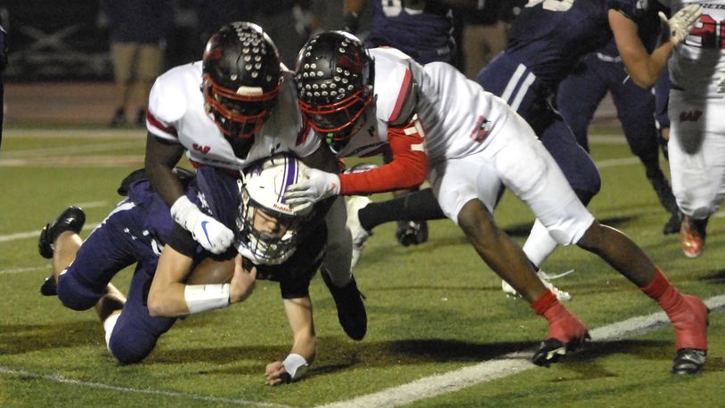 Lakota West's Cole Munday and Taebron Bennie-Powell (right) tackle an Elder ball carrier during a Division I regional semifinal game on Friday, Nov. 11, 2022. Bennie-Powell signed with Notre Dame on Wednesday, the first day of the national signing period. DAVID A. MOODIE/CONTRIBUTING PHOTOGRAPHER