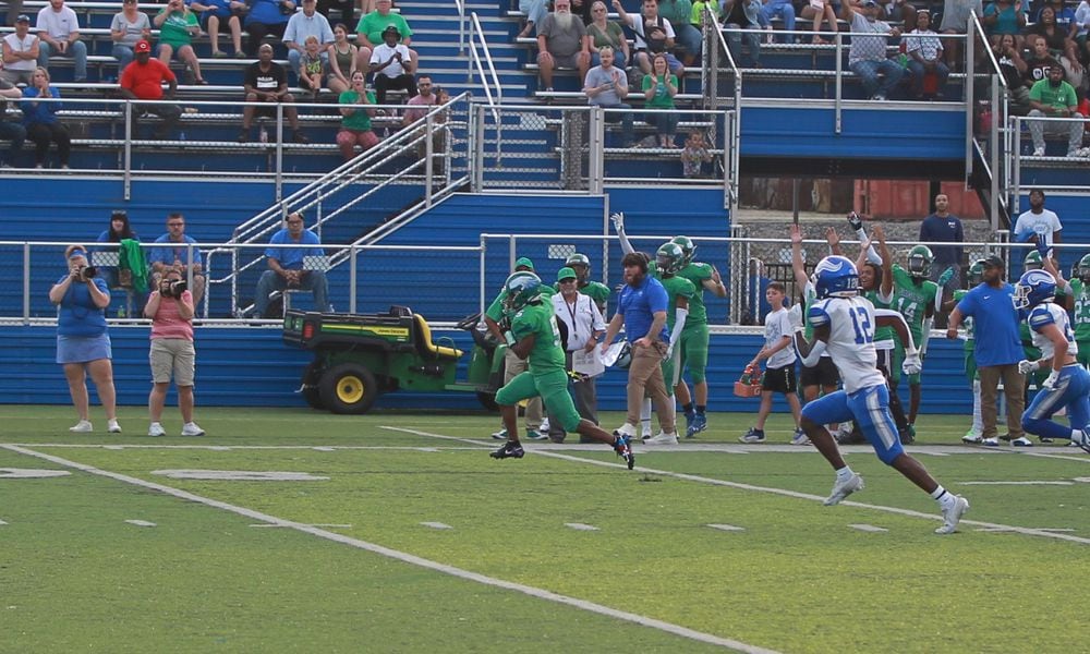 Aiden Lowery of Chaminade Julienne runs for a touchdown in the first quarter of CJ's win over Miamisburg on Aug. 23, 2024, in Dayton.