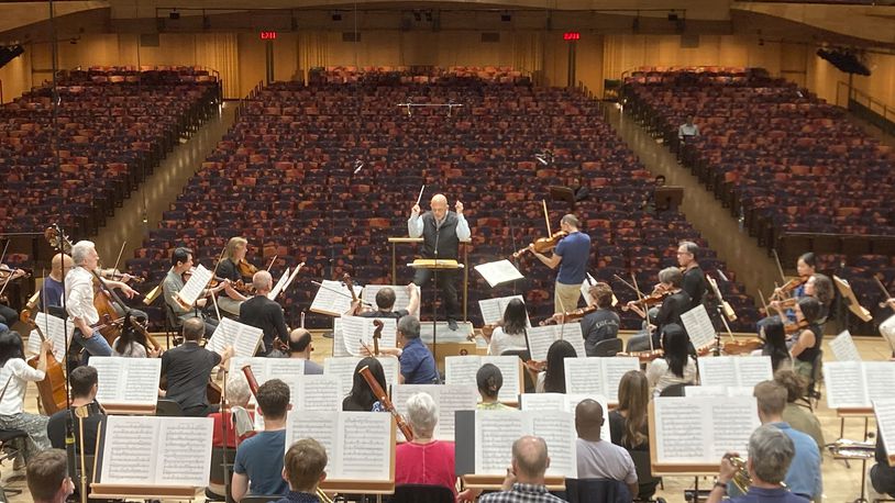 FILE - Jaap van Zweden, background center, conducts the New York Philharmonic in a rehearsal with viola soloist Antoine Tamestit at David Geffen Hall in New York, May 22, 2024. (AP Photo/Ronald Blum, File)