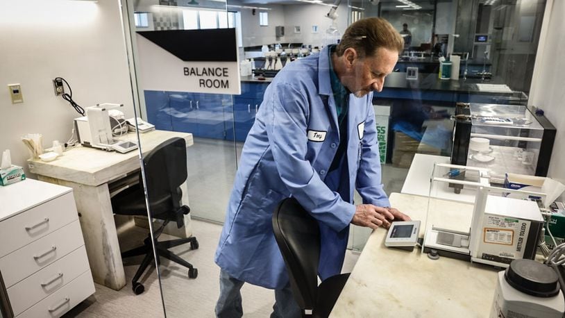 Montgomery County Environmental chemist Tony Miley uses a scale to weigh chemicals at the new Montgomery County Environmental Service lab. The new multi-million dollar lab located in the basement of park garage adjacent to the Montgomery County administration building. JIM NOELKER/STAFF