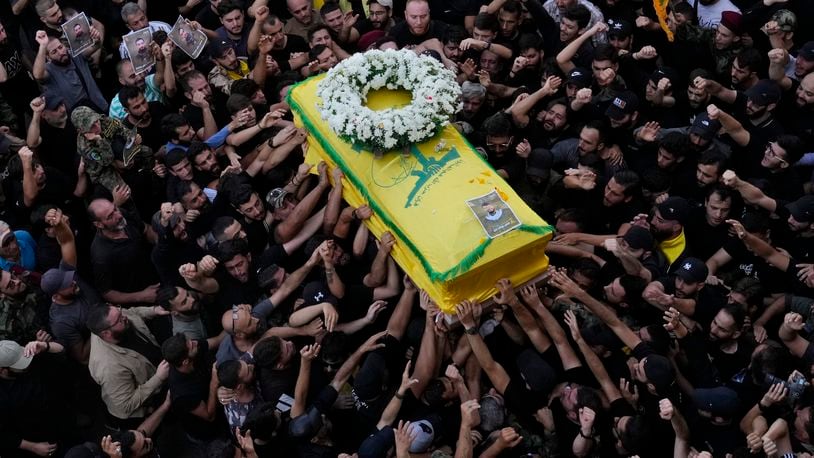 Hezbollah members carry the coffin of their comrade who was killed on Wednesday when a handheld device exploded, during a funeral procession in the southern suburbs of Beirut, Thursday, Sept. 19, 2024. (AP Photo/Hussein Malla)