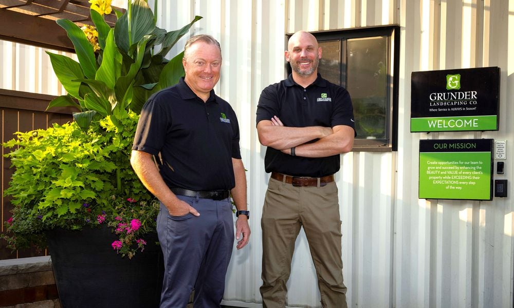 Grunder Landscaping Co. founder and CEO Marty Grunder and company President and Chief Operating Officer Seth Pflum stand outside Grunder Landscaping at 1900 Byers Road in Miamisburg. Founded in 1984, the business recently launched renovations on a Loveland facility ahead of a planned November opening. CONTRIBUTED