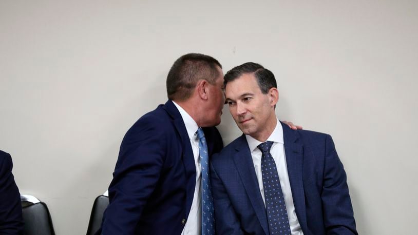 Dominion Energy South Carolina President Keller Kissam, left , and Duke Energy's utility operations in South Carolina President Mike Callahan, speak before testifying before a South Carolina Senate committee planning to write a comprehensive energy bill in 2025 in Columbia, S.C., on Thursday, Aug. 22 2024. (AP Photo/Jeffrey Collins)