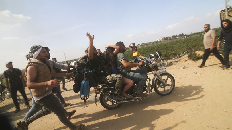 FILE - Palestinians transport a captured Israeli civilian, Noa Argamani, on a motorcycle from southern Israel, in the Gaza Strip on Oct. 7, 2023. Victims of Hamas' Oct. 7 attack in Israel sued Iran, Syria and North Korea on Monday, July 1, 2024, saying their governments supplied the militants with money, weapons and know-how needed to carry out the assault that precipitated Israel's ongoing war in Gaza. (AP Photo)