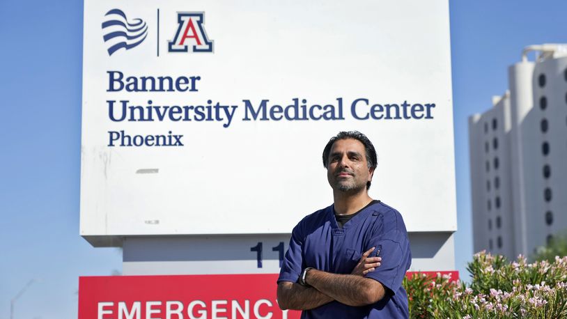 Dr. Aneesh Naran stands outside the Banner University Medical Center emergency room after his shift, Monday, Oct. 7, 2024 in Phoenix. (AP Photo/Matt York)