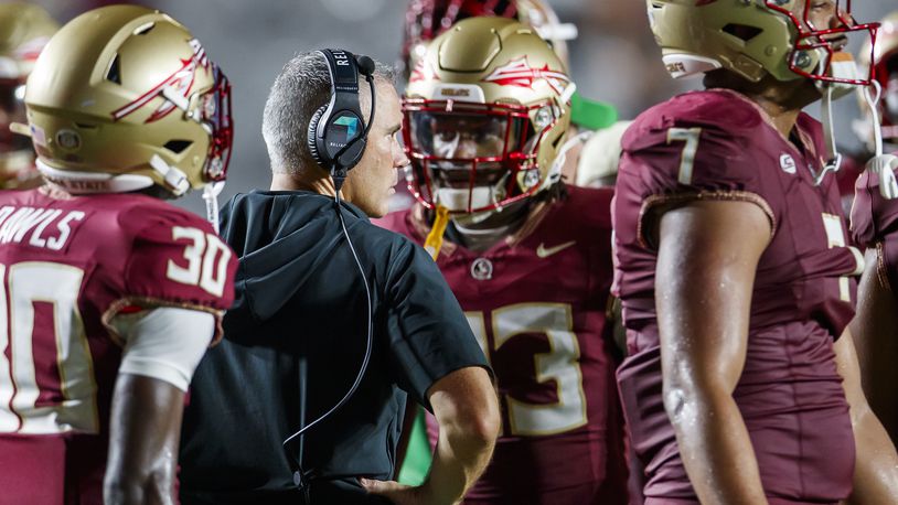 Florida State head coach Mike Norvell, center left, is surrounded by his team in the final seconds of an NCAA college football game against Boston College, Monday, Sept. 2, 2024, in Tallahassee, Fla. (AP Photo/Colin Hackley)