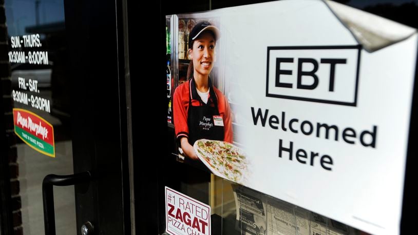 FILE - A sign notifies customers that EBT can be used at a store in Sioux Falls, S.D., Aug. 26, 2011. A committee of lawmakers in West Virginia’s Republican-majority Legislature is advancing a bill that would require low-income residents who qualify for government assistance buying food to provide a photo identification card before making purchases. (Jay Pickthorn/The Argus Leader via AP, File)