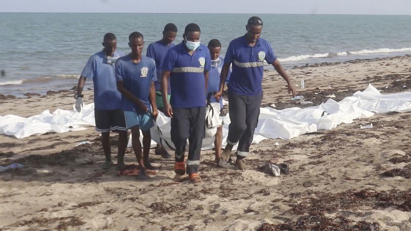 In this image made from video, Djiboutian coast guard workers load bodies of migrants who were washed away on the shore of the Red Sea, off the coast in Djibouti Wednesday, Oct. 2, 2024. The U.N. migration agency says two vessels carrying migrants from Africa sank in the Red Sea killing 45 people. (Djiboutian Coast Guard via AP)