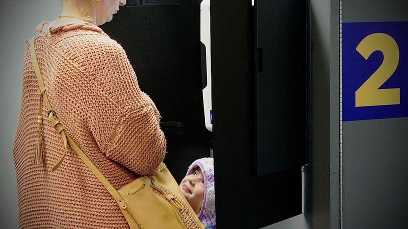 Clara Kerr, 5, smiles at her mom Holly as she votes Tuesday, Nov. 2. Marshall Gorby/Staff Photo